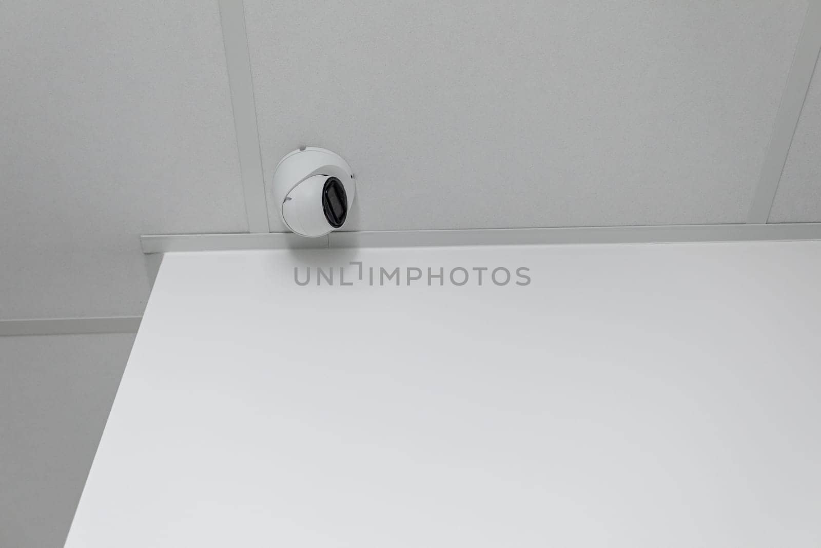 A stylish surveillance camera captures security in a simple environment, enhancing safety and monitoring
