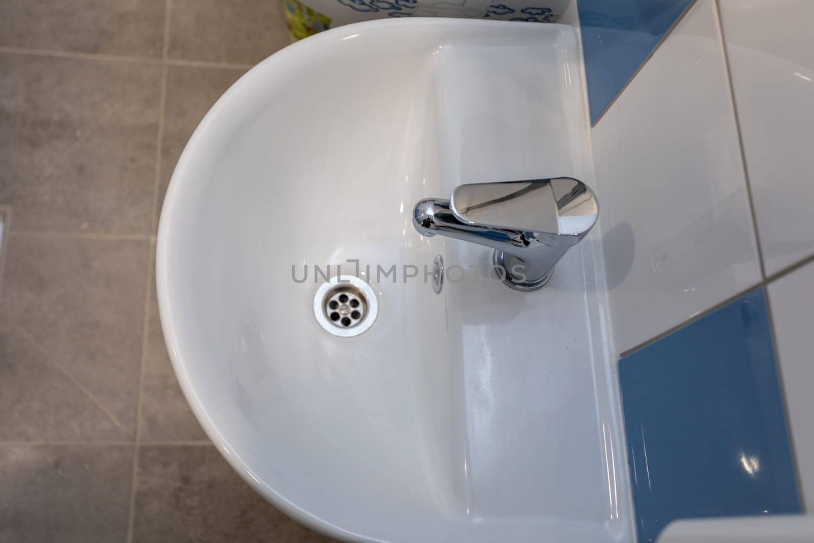 This stylish bathroom sink beautifully showcases its sleek design along with a modern chrome faucet feature