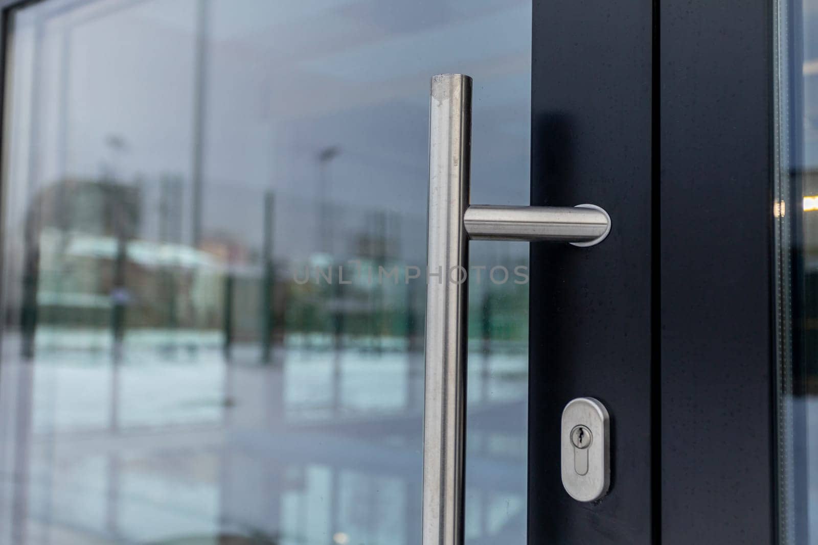 A sleek and sophisticated door handle, showcasing elegant modern design elements made of glass and metal materials