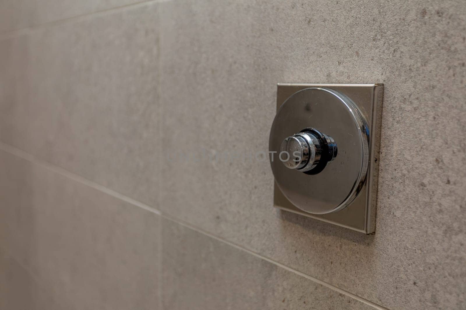 A closeup view of a sleek and stylish shower control valve that has been expertly installed on a contemporary wall