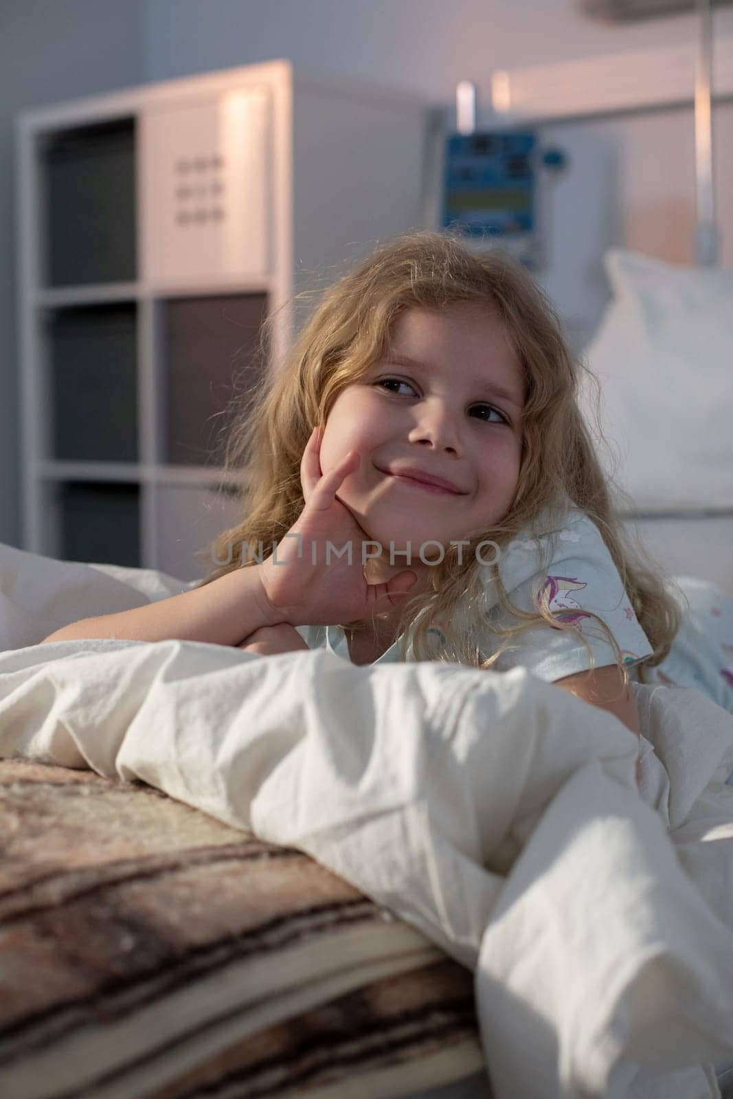 A cheerful girl is happily relaxing on a cozy bed, radiating joy and curiosity in a warm environment