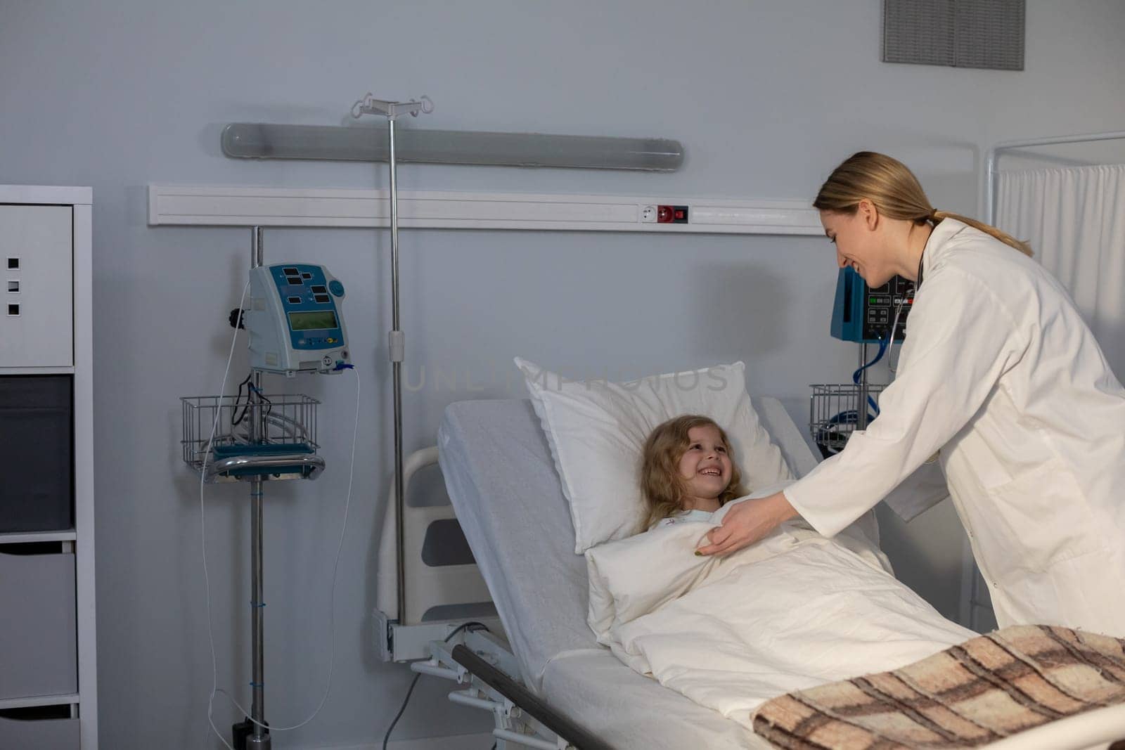 A dedicated doctor caring for a young patient in a hospital room, showing compassion and professionalism
