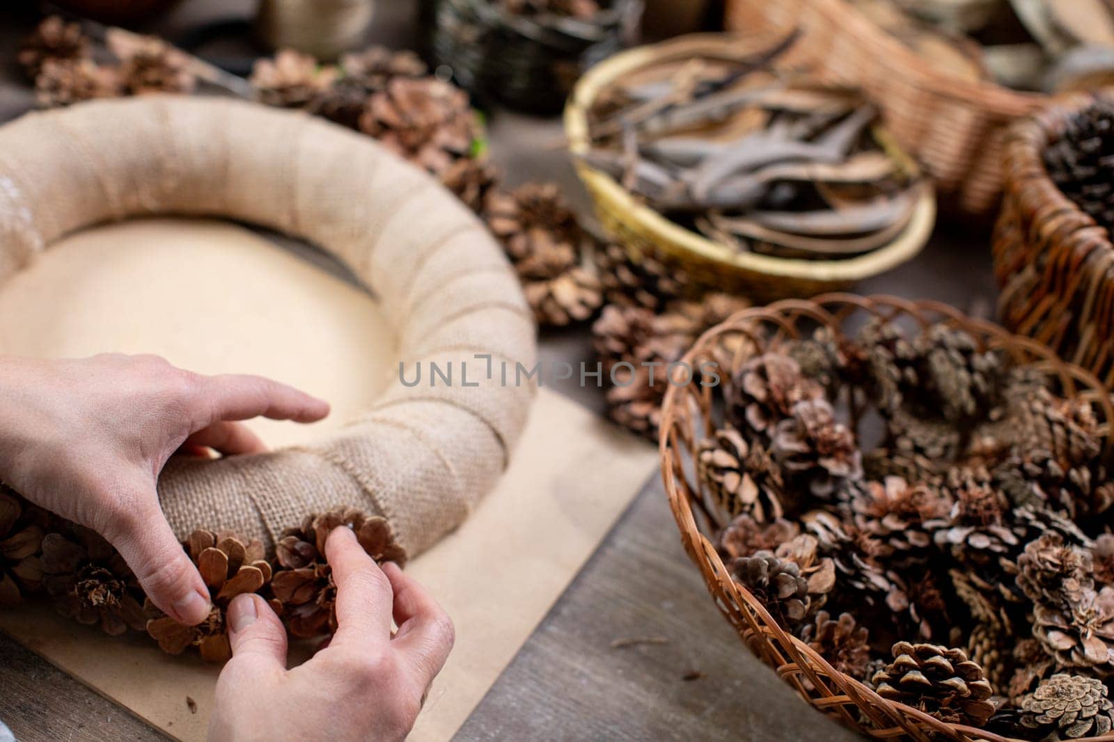 Creating a stunningly beautiful wreath made from natural materials such as pinecones, twine, and more