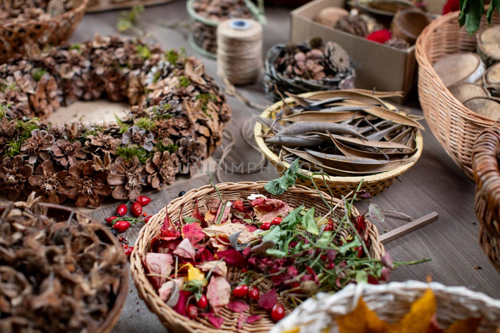 A beautifully vibrant arrangement rich in various natural herbs and assorted dried flowers placed in woven baskets