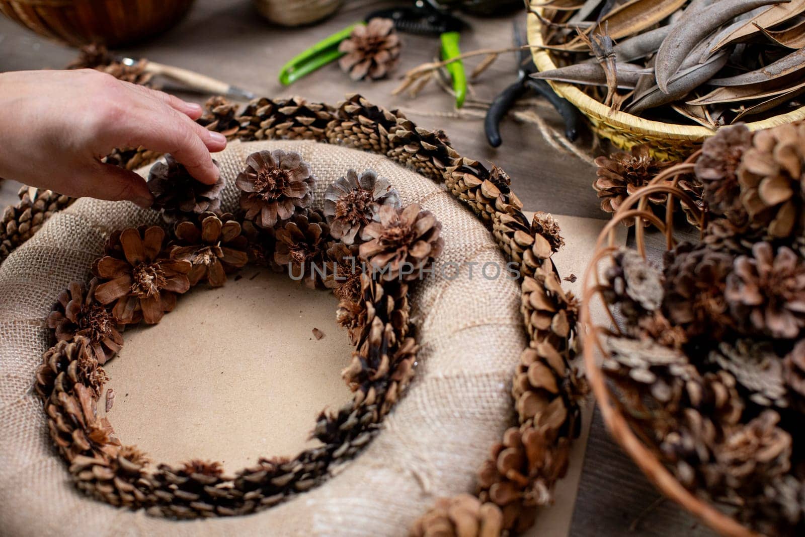 Handcrafting a cozy and beautiful pinecone wreath using natural elements for lovely seasonal decoration
