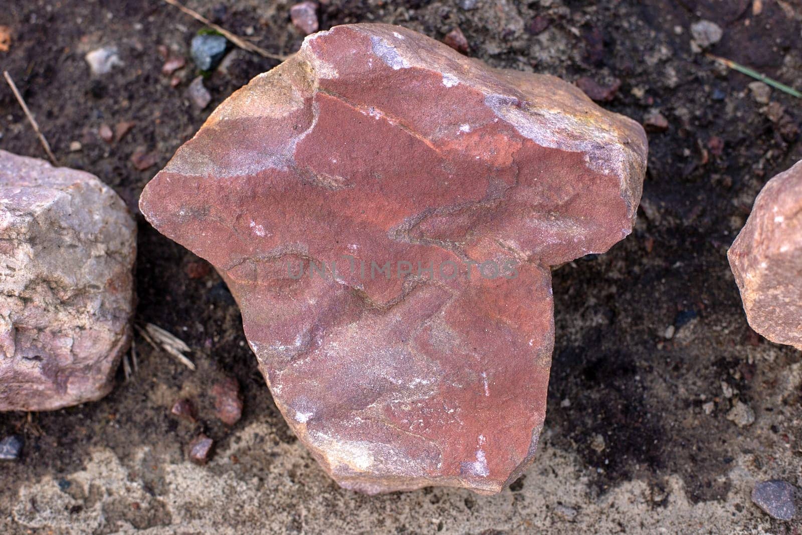 Pink sandstone stone on the dark ground. close-up