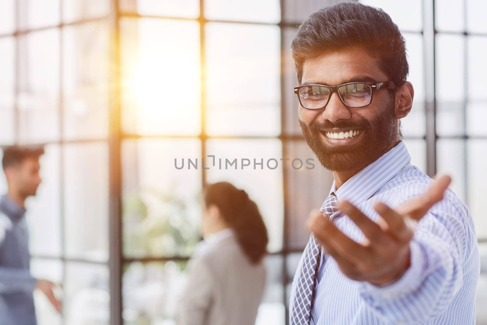 male investor beard looking at camera and smiling in modern office