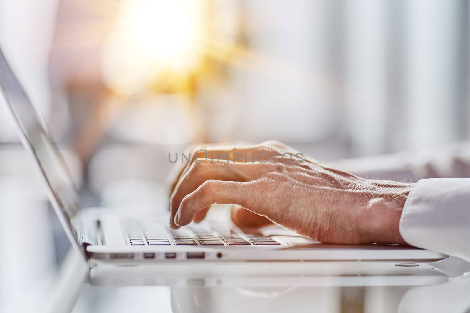 man's hands typing on laptop. Brown male hands pressing buttons on laptop computers.