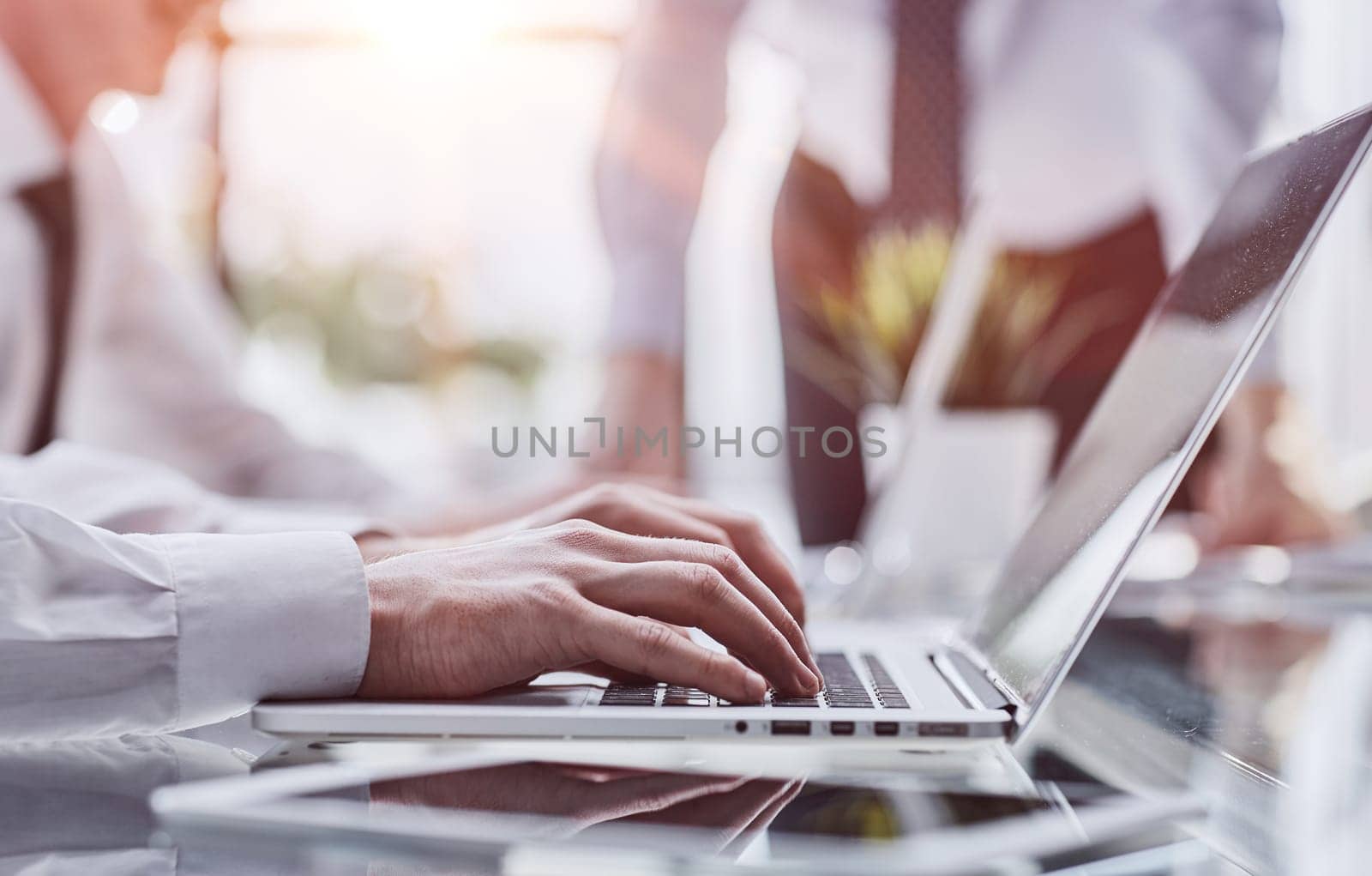Man hands typing on laptop computer keyboard, close up.