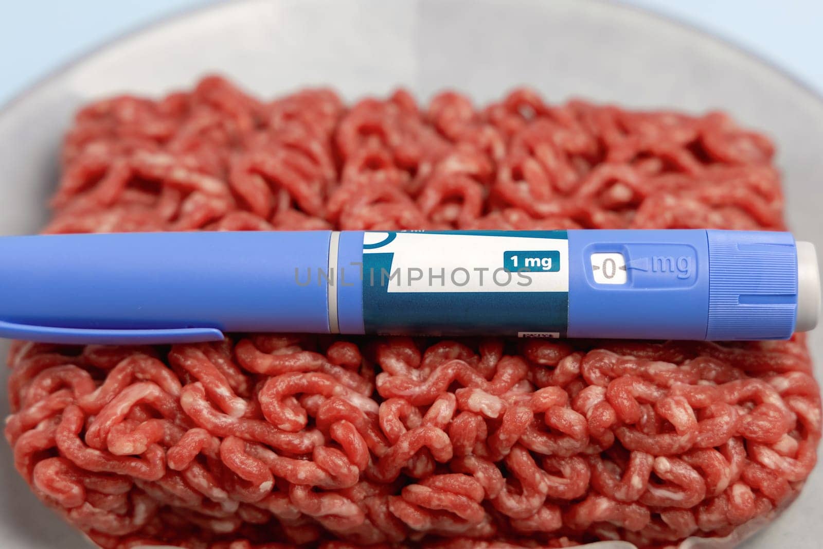 Ozempic Insulin injection pen and raw minced meat for diabetics and weight loss. High quality photo