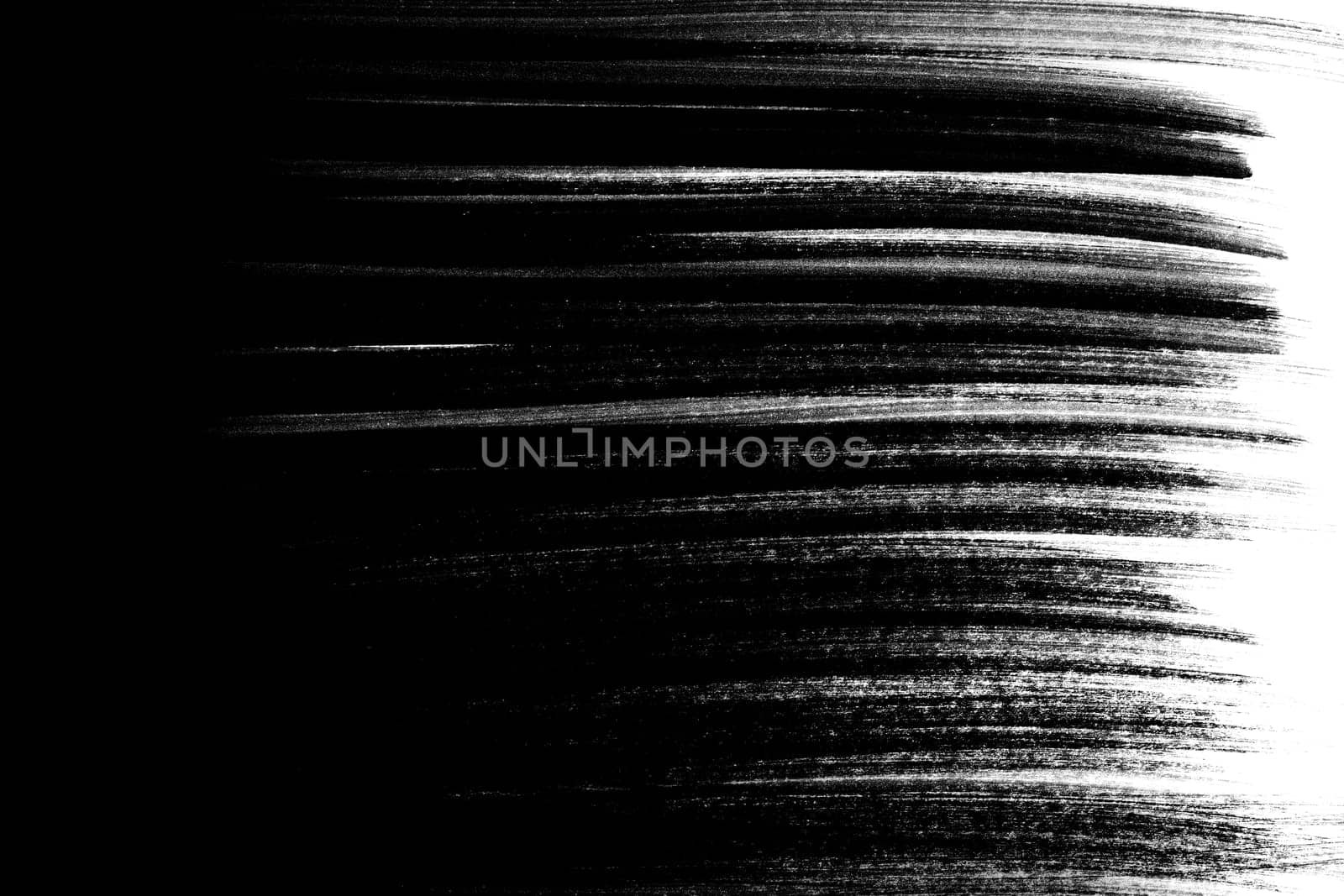 Irregular black brush strokes as a gradient on a white background.