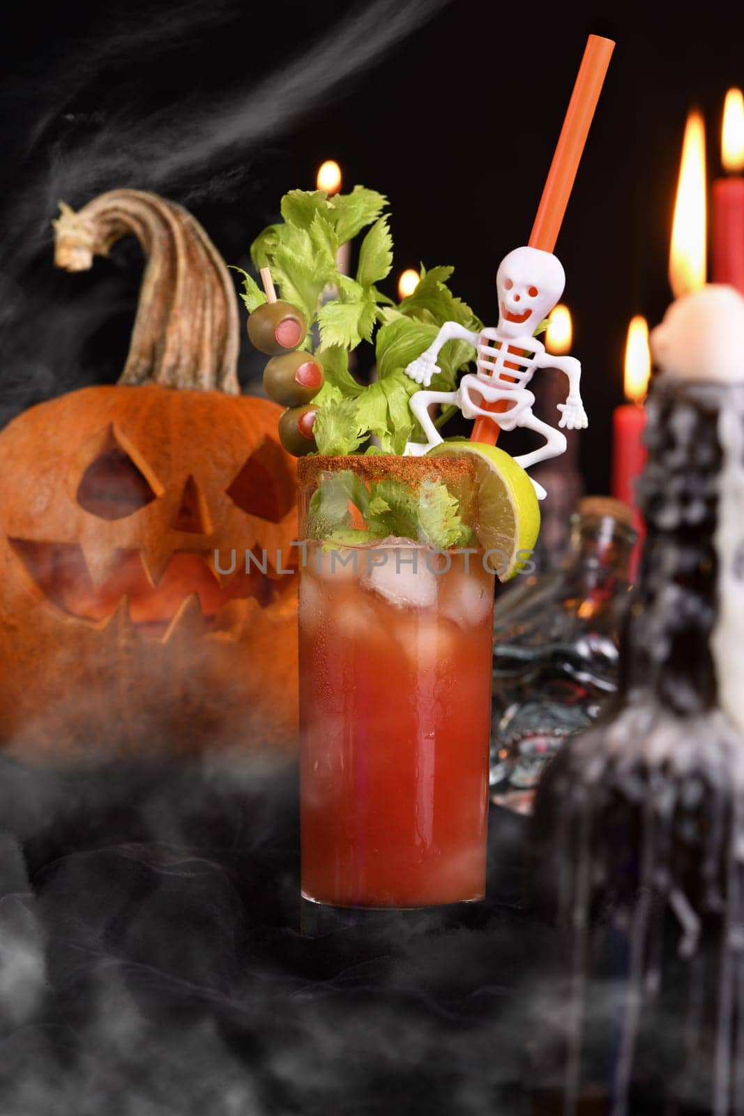 Bloody Mary cocktail. Tomato juice and vodka, garnished with celery stalk, lime and olives. Halloween party ideas