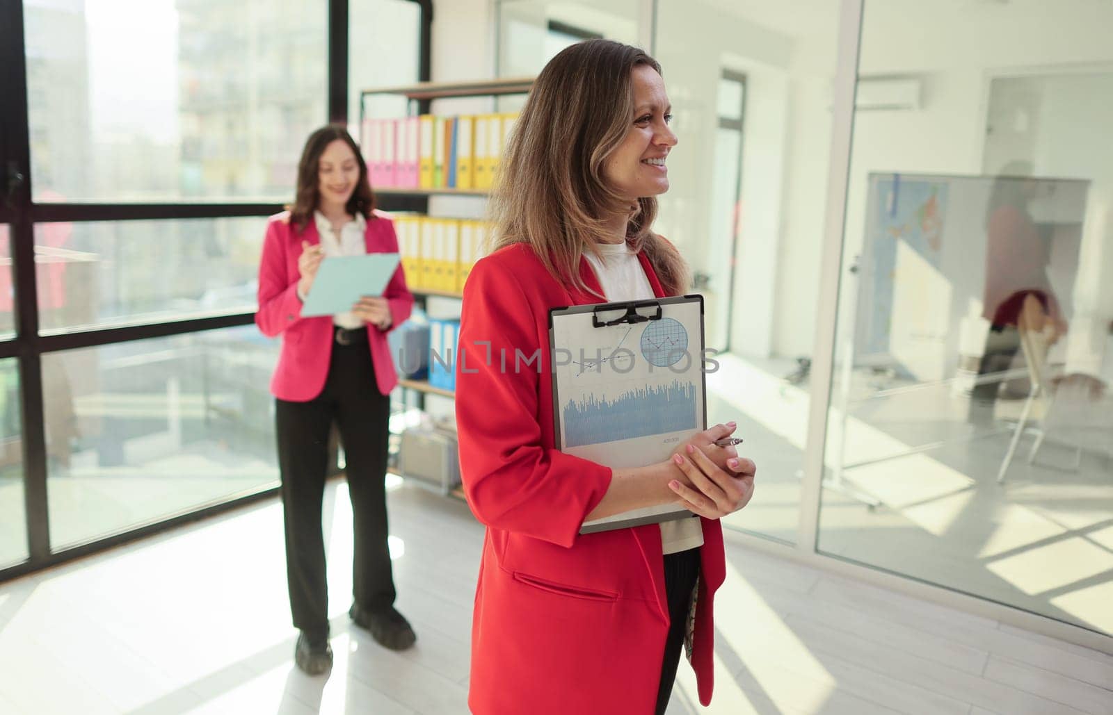 Two office workers sorting and arranging important documents.