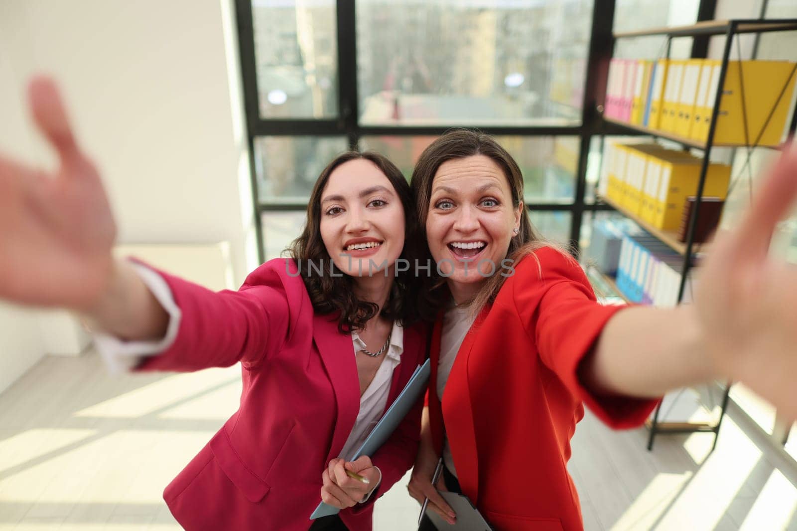 Confident business leaders posing in a modern corporate environment.