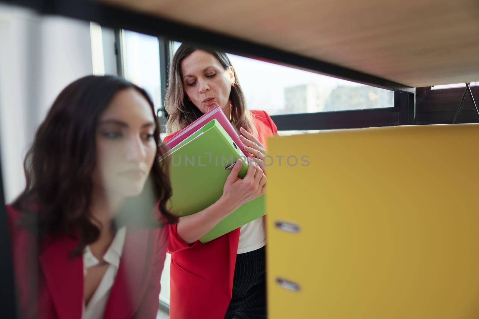 Coworkers efficiently working together in a productive office.