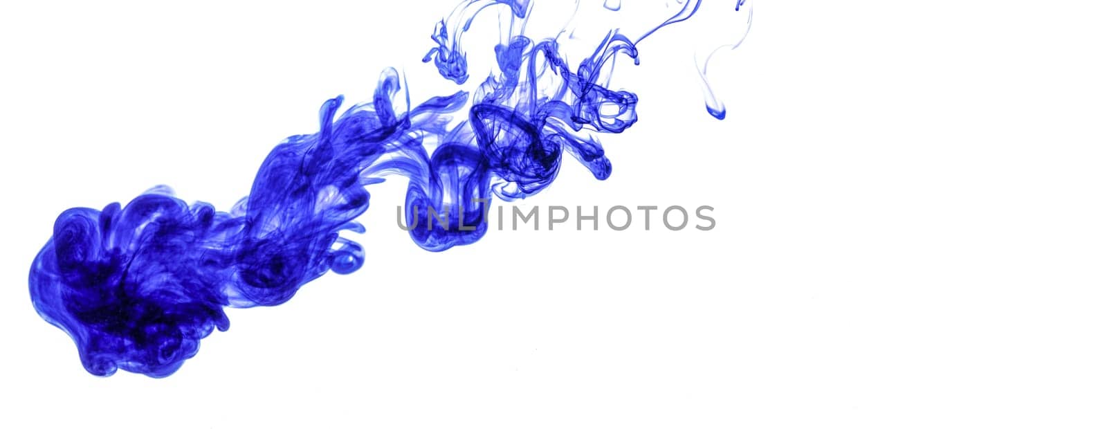Blue ink injected into water from syringe, colour mixing with water creating abstract shapes, white background banner with space for text right side