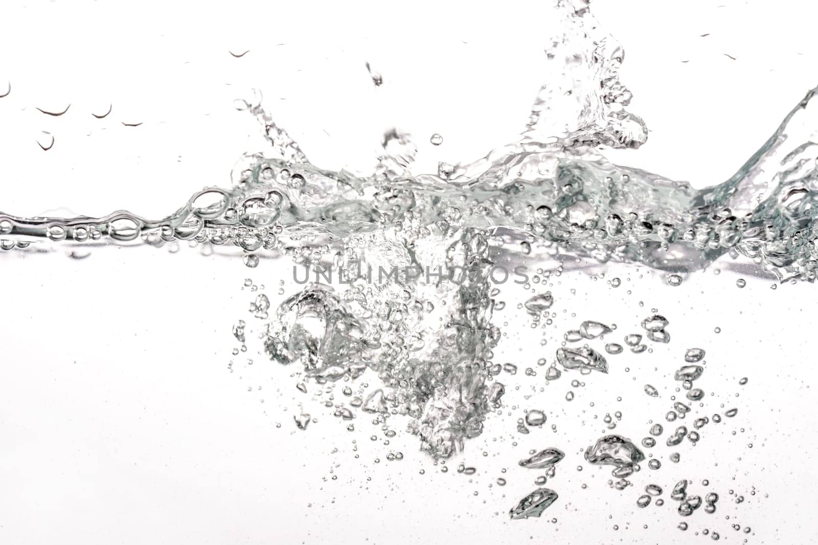 Water splashing as it's poured into tank, white background