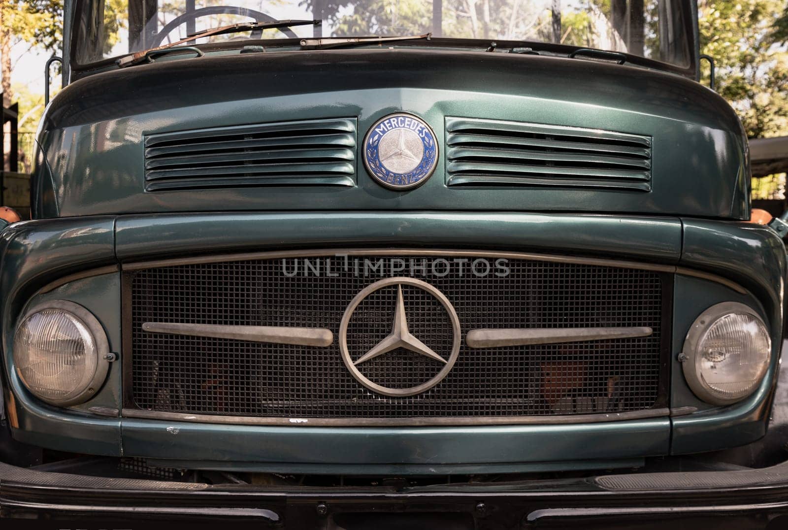 Bangkok, Thailand - Feb 19, 2025 - Front of a classical Mercedes Benz green truck in Close up. Timeless designs, use it as your Wallpaper, Poster and Space for text, Selective focus.