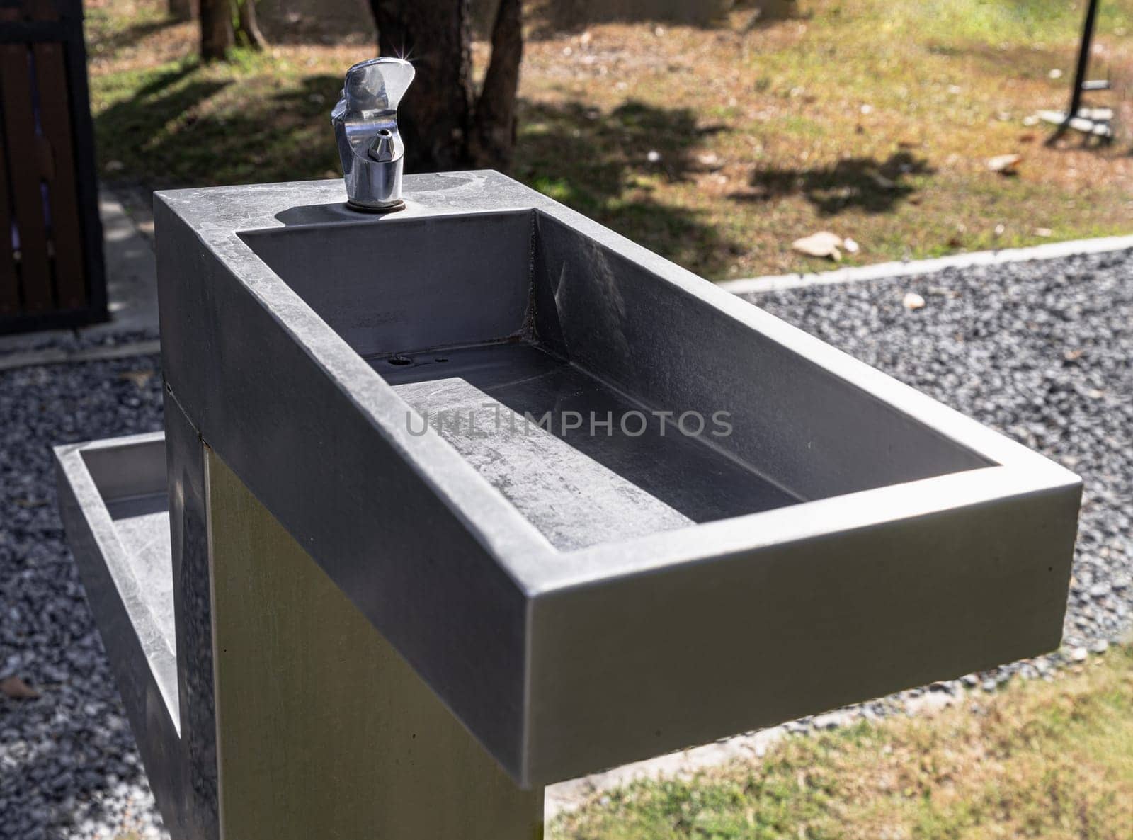 Outdoor drinking fountain. Public fountain that provide free drinking water for peoplein city park on a sunny day, use it as your Wallpaper, Poster and Copy space, Selective focus.