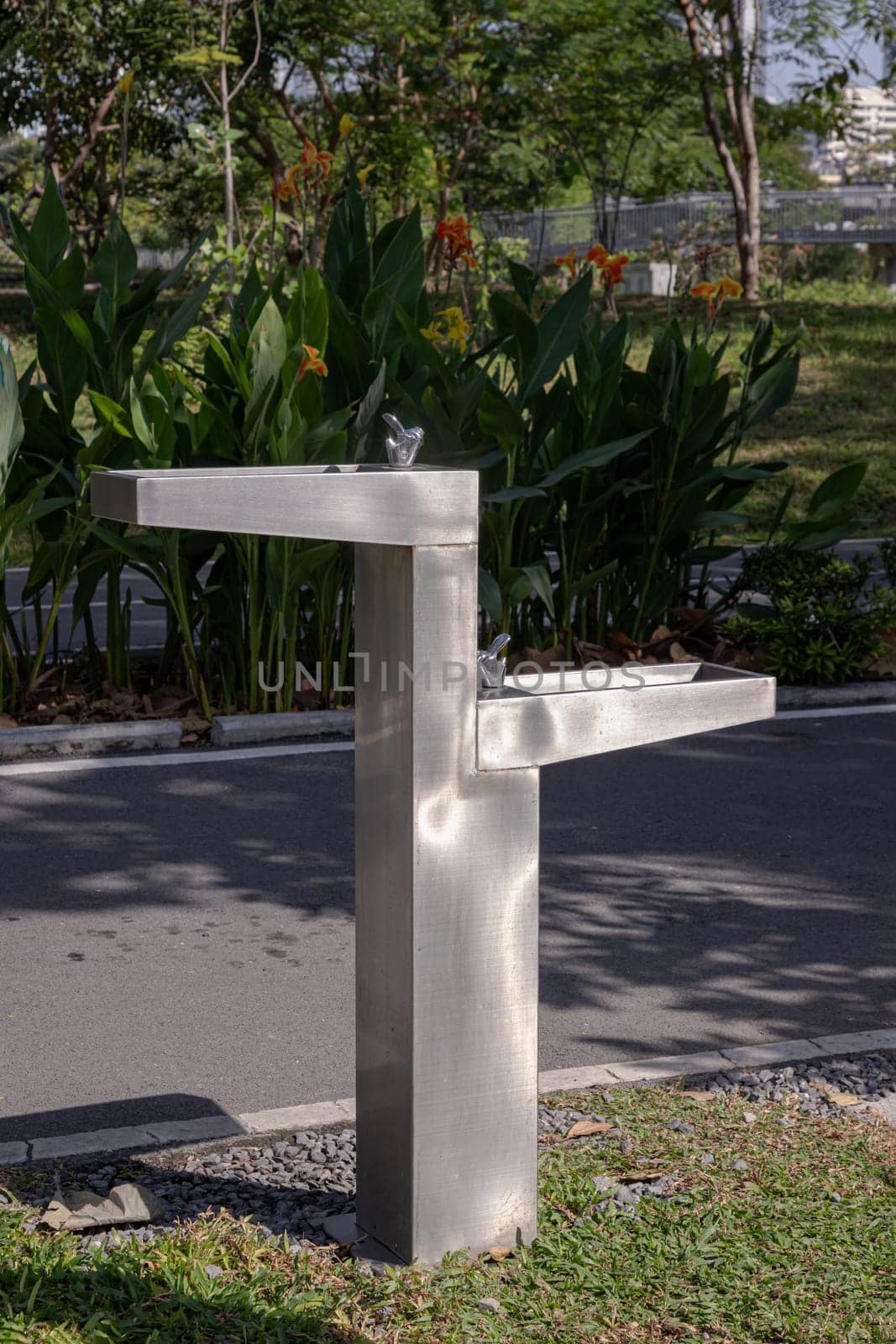 Outdoor drinking fountain. Public fountain that provide free drinking water for peoplein city park on a sunny day, use it as your Wallpaper, Poster and Copy space, Selective focus.