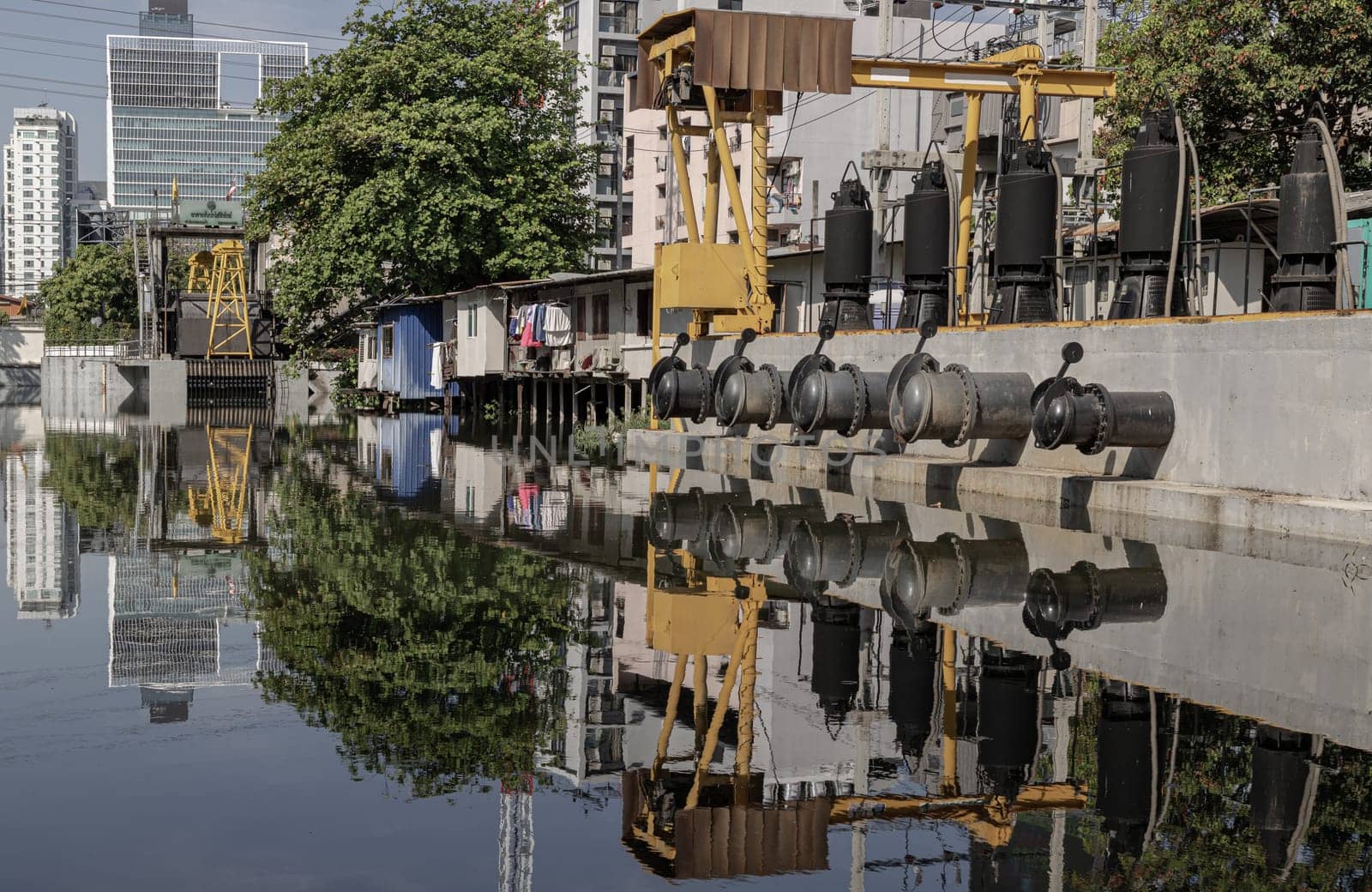 Bangkok, Thailand - Feb 19, 2025 - A pumping station along a canal in Sukhumvit soi 4. The station pumps that uses pumps to move water or wastewater from one place to another. They are also known as pumphouse. use it as your Space for text, Design, Wallpaper and Poster, Selective focus.