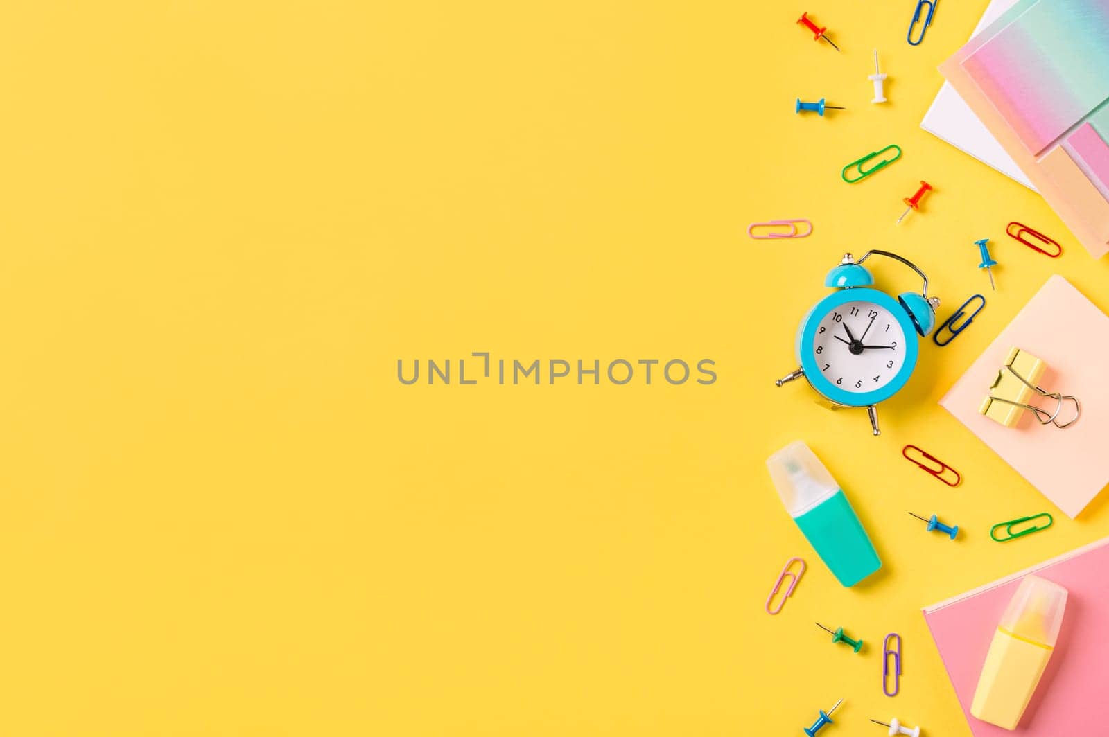 Education, back to school, e-learning, online study, distantly learning class, freelancer work concept. School supplies, stationery accessories along bottom edge on yellow background. Flat lay, top view. Copy space