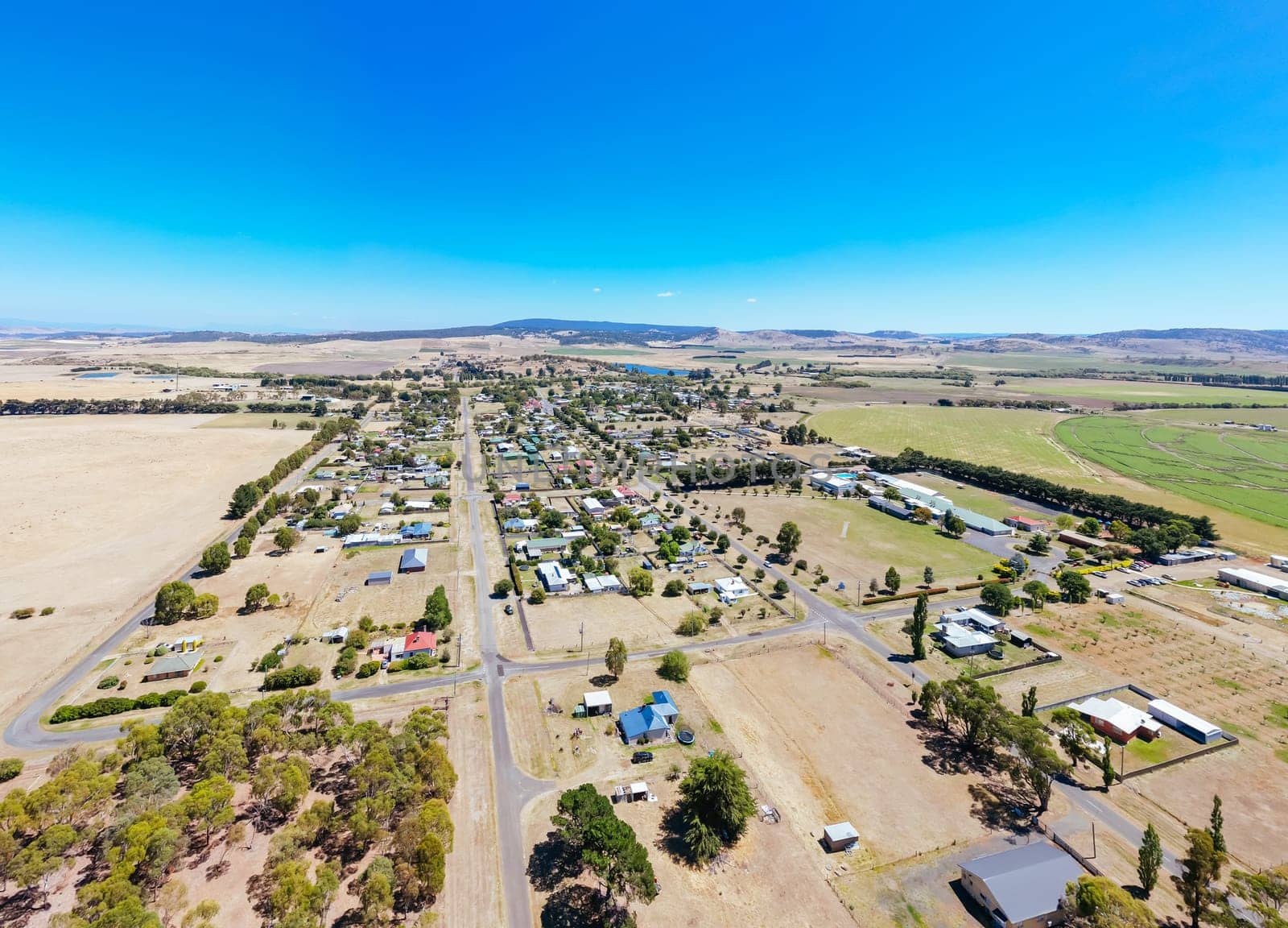 BOTHWELL, AUSTRALIA - FEBRUARY 06 2025: Aerial view of the rural historic town of Bothwell on a warm summer's day in Tasmania, Australia