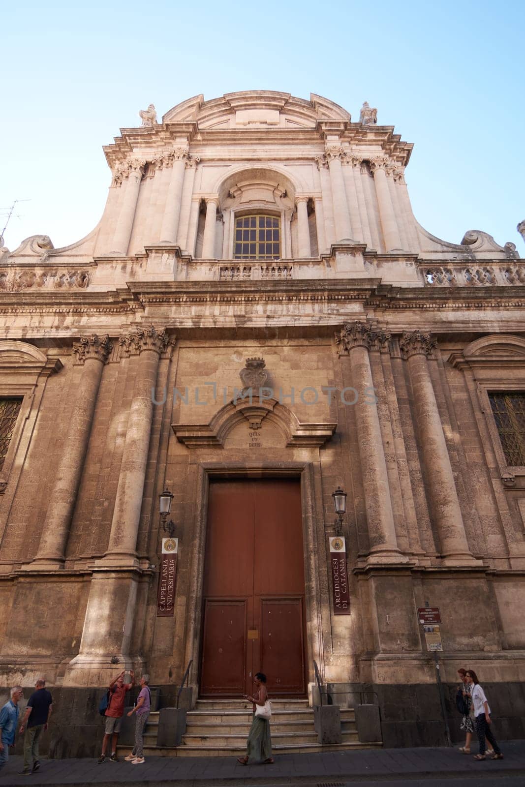 Catania. Italy - February 27, 2025: The grand San Michele Arcangelo ai Minoriti church towers over Catania lively streets Perfect for travel photography architectural features, and cultural narratives