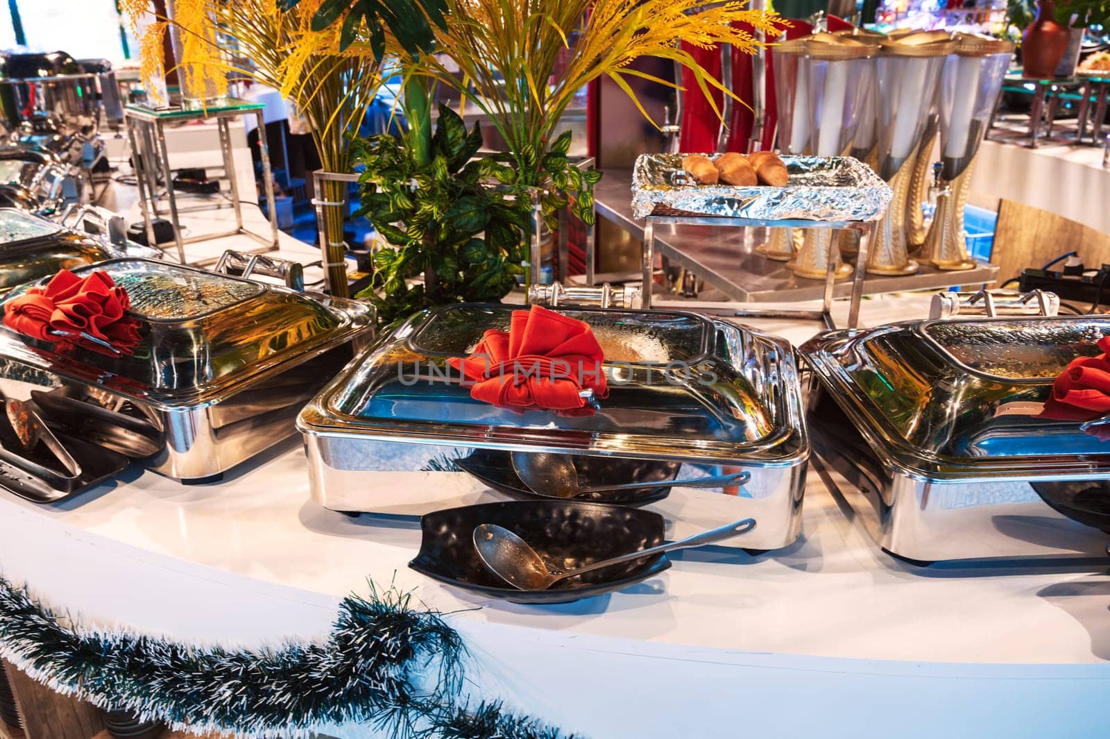 hot dishes in pots on the buffet table in the self-service restaurant at hotel