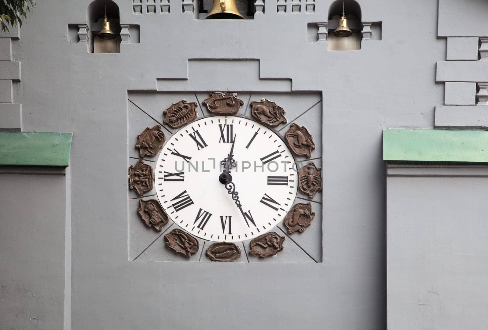 A large analog clock is prominently featured on a gray wall of a Clock Tower of a State bank in Nizhny Novgorod