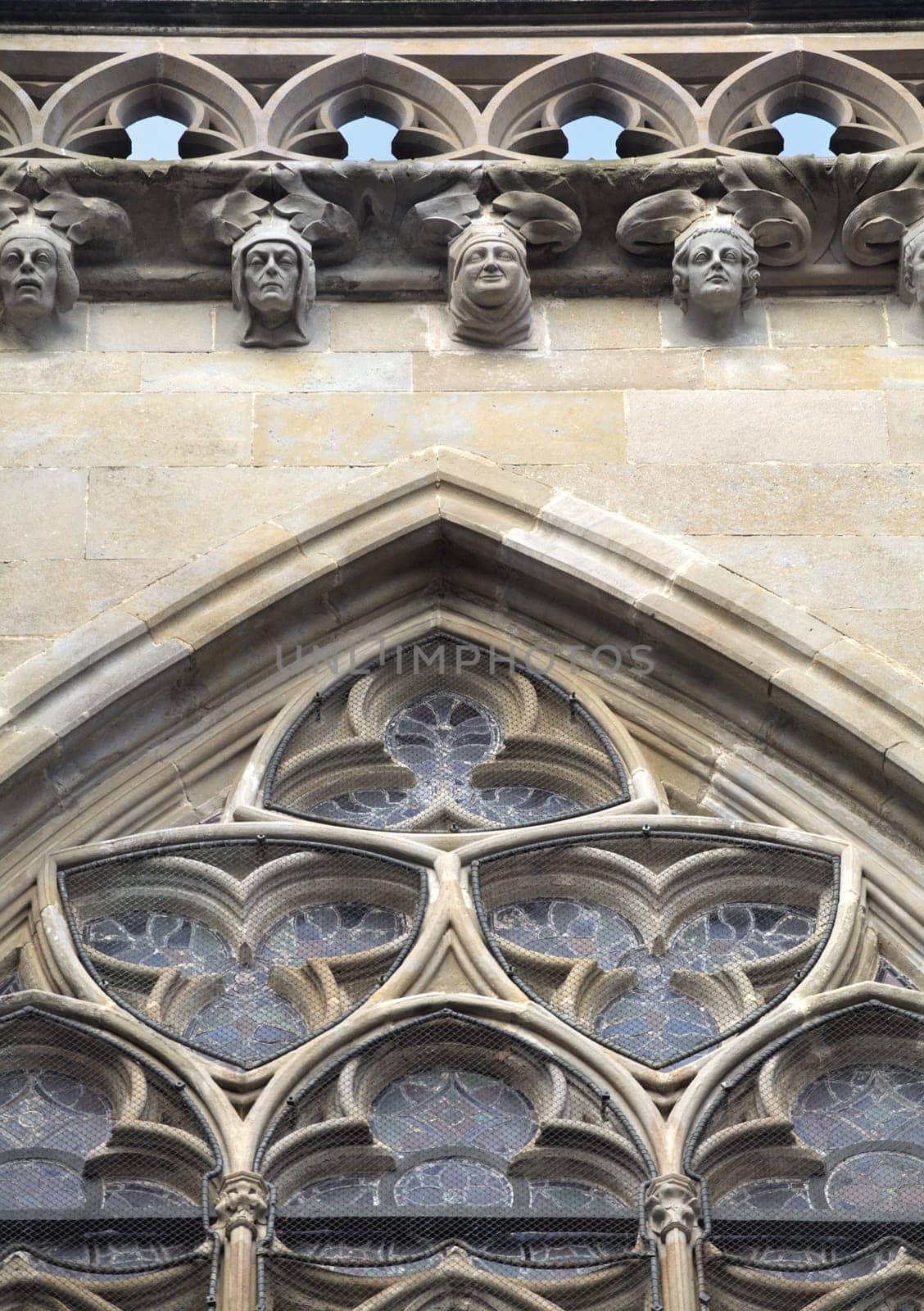 Intricate stonework adorns a historic facade in Carcassonne, France, showcasing artistry.