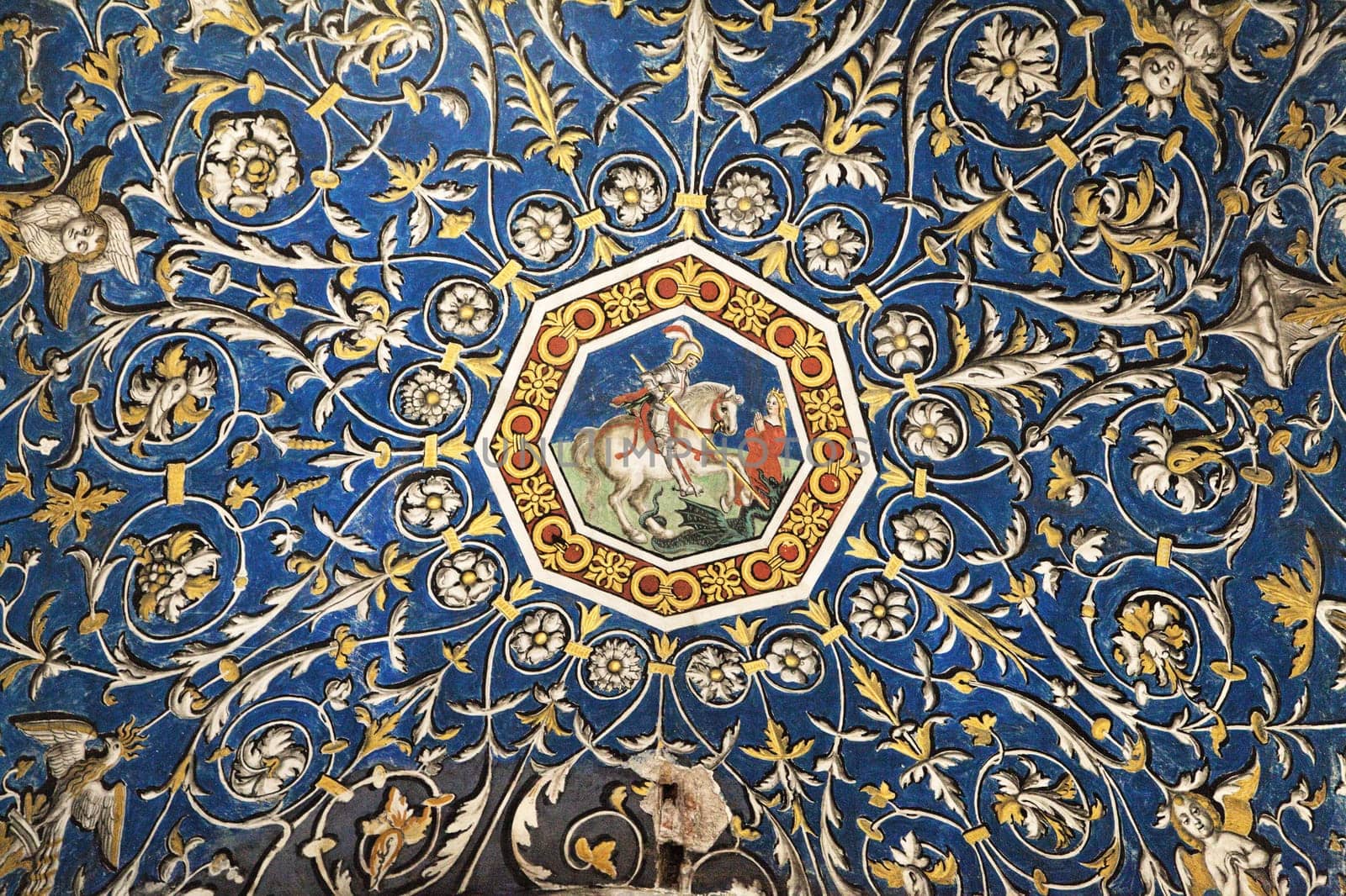 Colorful floral patterns surround a central depiction of a knight riding a horse, showcasing the cathedral's artistry.