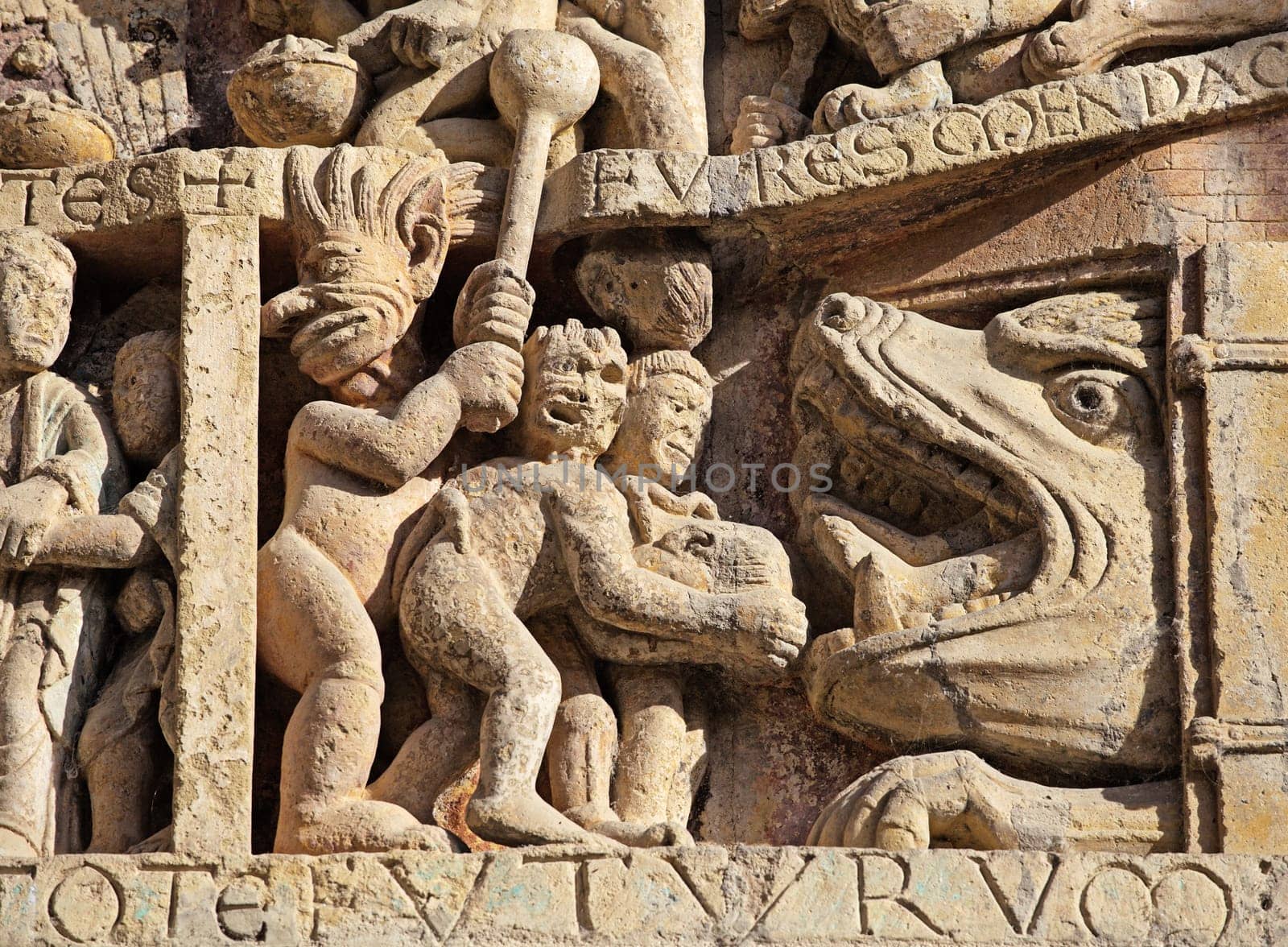 Stone reliefs showcase detailed figures and events from history, offering insight into the art of Conques, France.