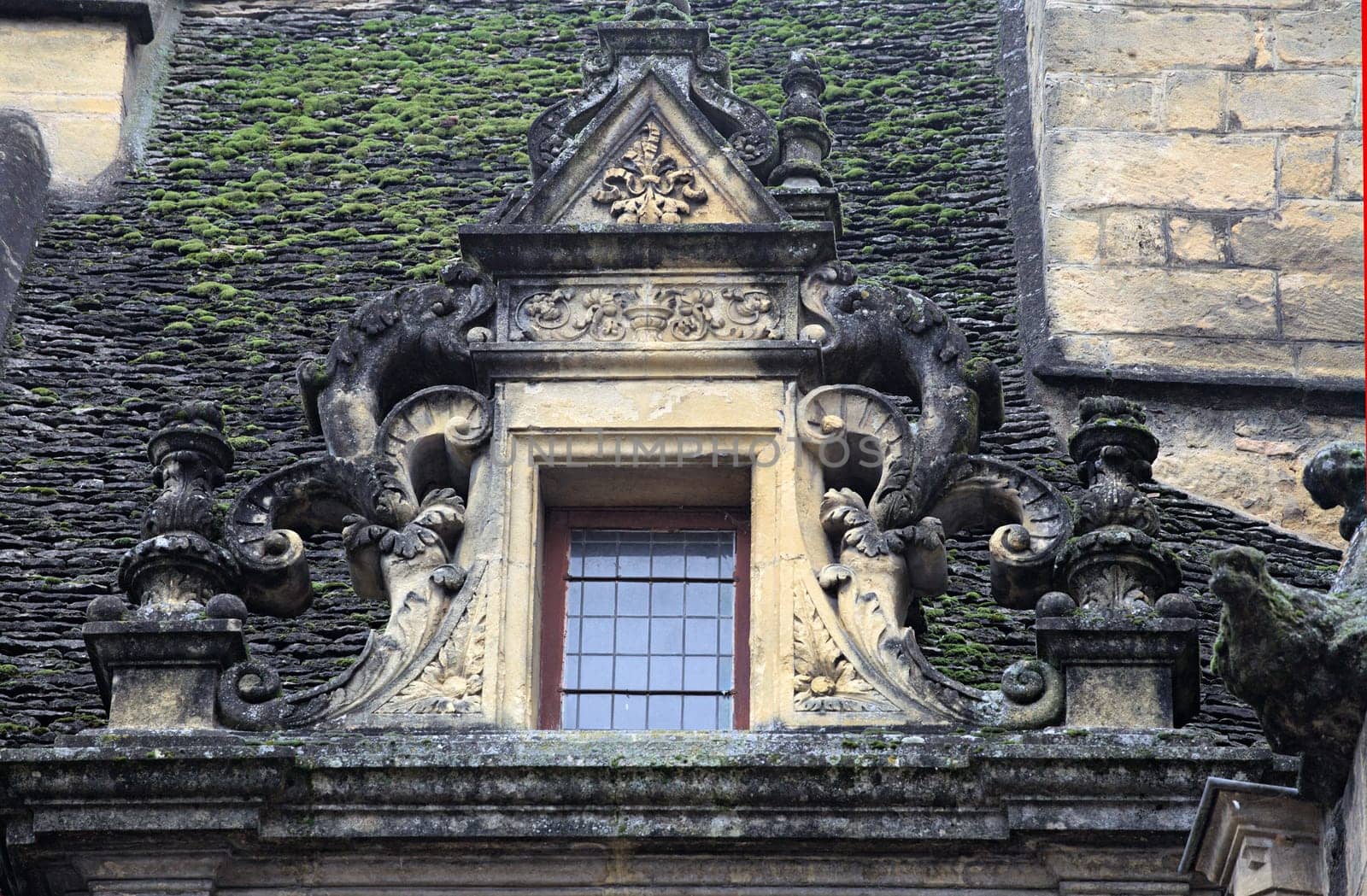 Ornate stone carvings adorn a historic structure in Sarlat-la-Caneda, highlighting its rich architectural heritage.