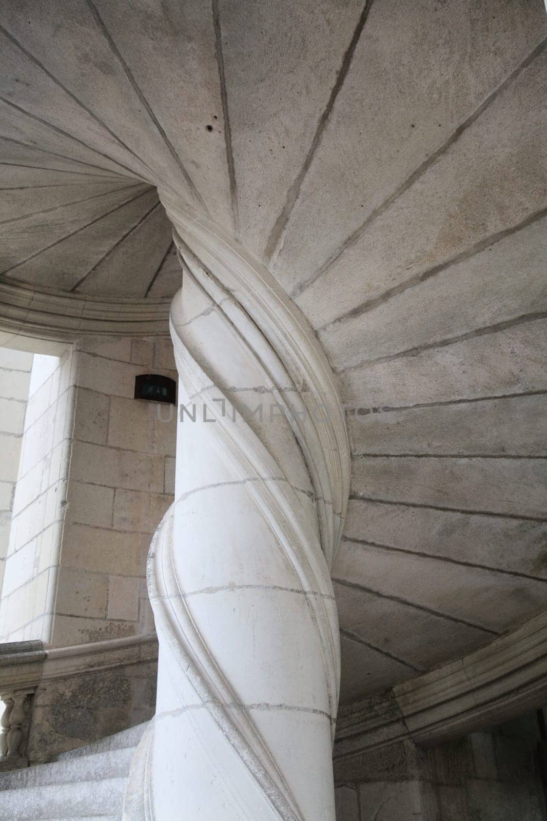 The spiral staircase at Chambord Castle boasts stunning details and elegant curves, inviting exploration.