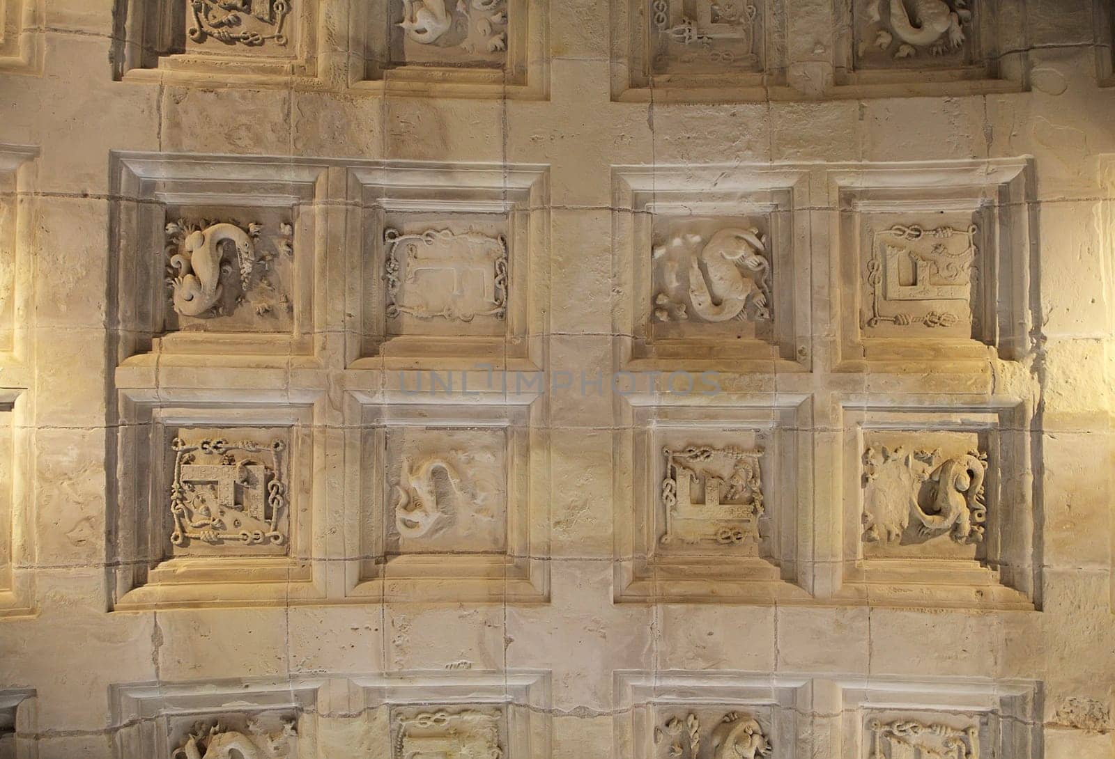 Elaborate ceiling with detailed stone carvings in Chambord Castle highlights architectural beauty and history.