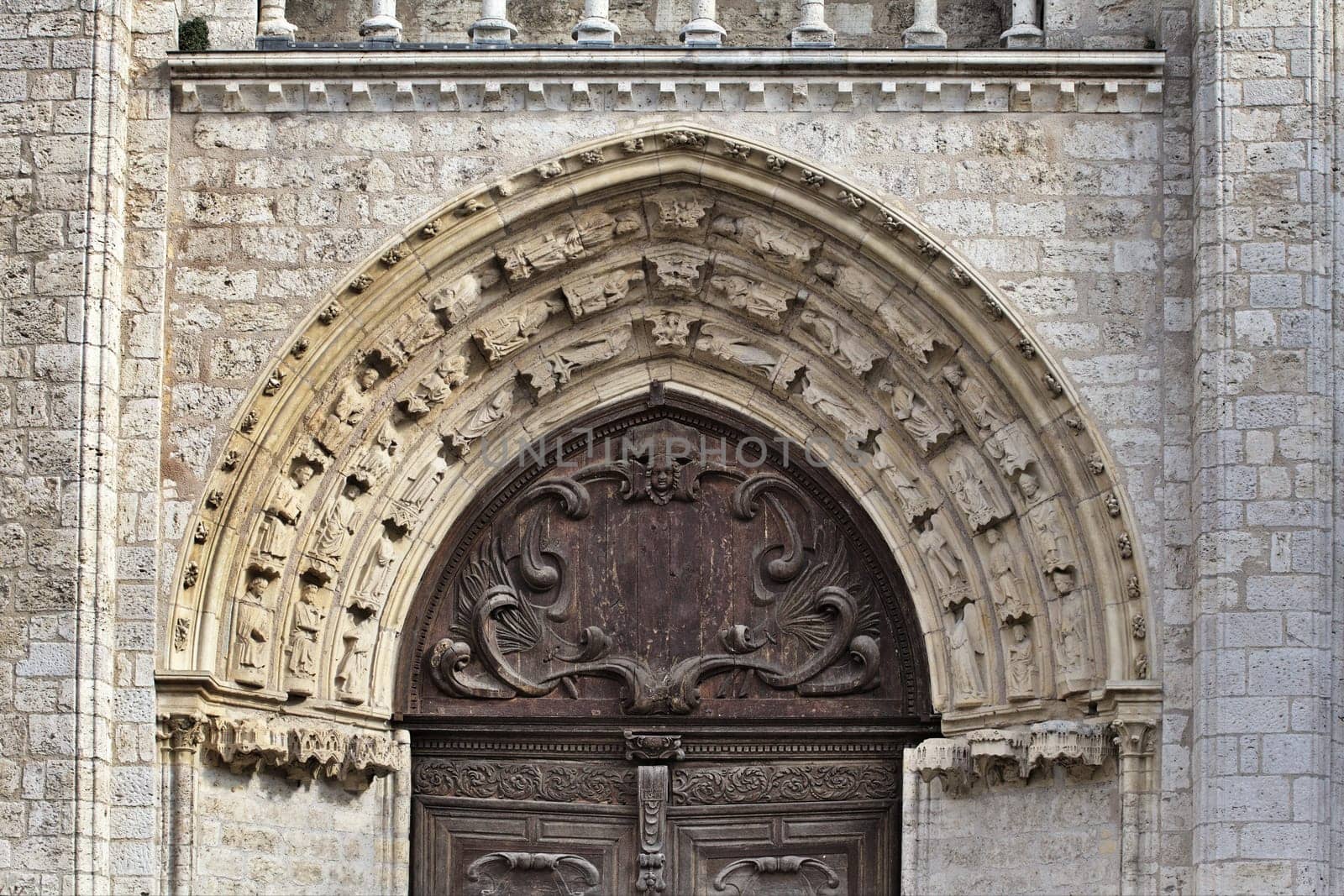 Close-up view of ornate stone arch and wooden door showcasing exceptional craftsmanship in Blois, France.