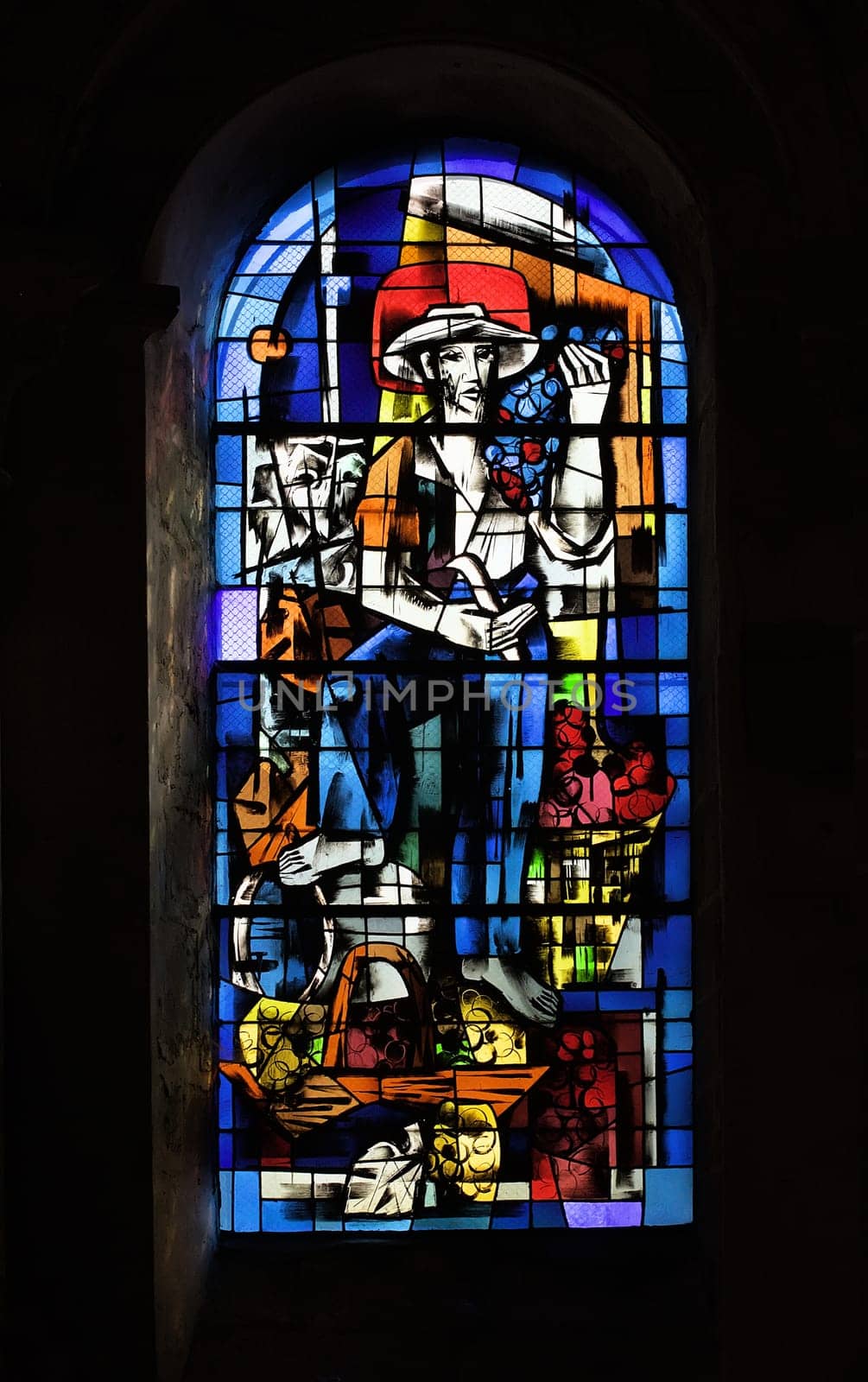 This stained glass window at the Church of Saint-Nicolas illustrates a farmer surrounded by baskets of produce in Blois.
