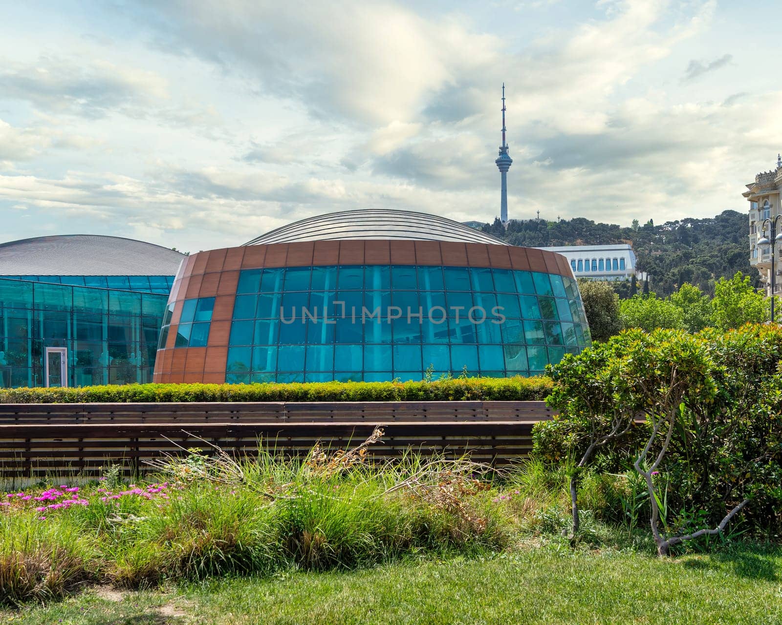 Contemporary architecture of the International Mugham Center, prominently situated in Baku, Azerbaijan, exemplifying its distinctive design with the Baku TV Tower in the background