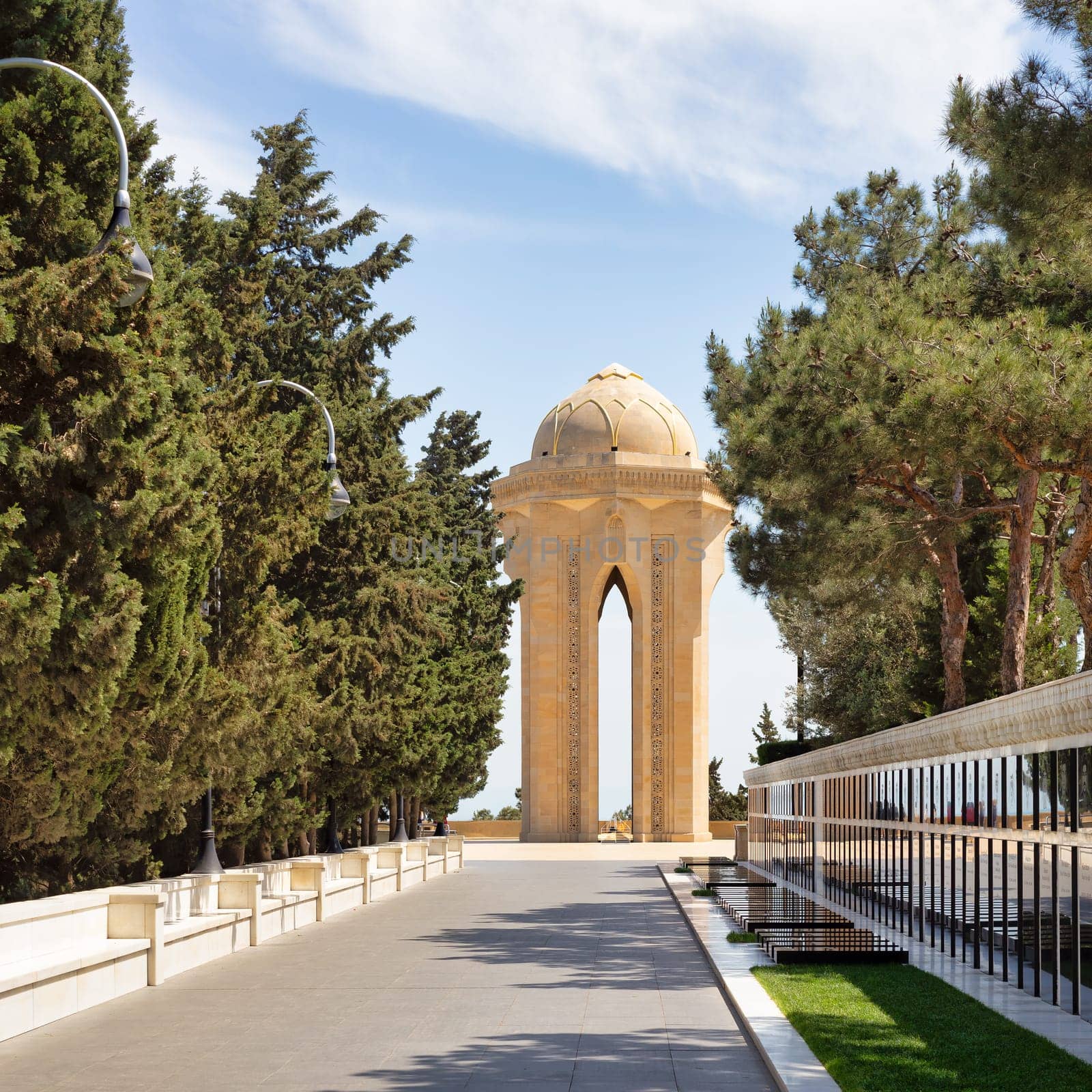 Baku, Azerbaijan - May 6 2024: Martyrs Lane honors fallen soldiers in the Nagorno-Karabakh Conflict. It features soldiers' graves and a central monument, an imposing stone tower with an eternal flame