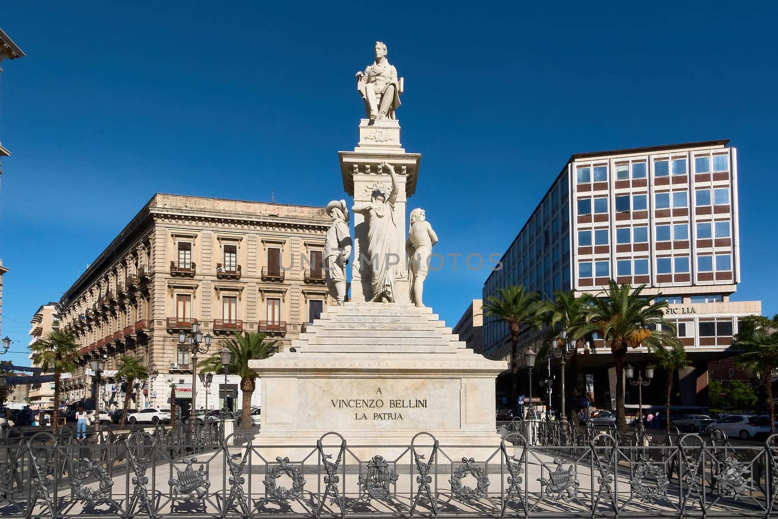 Catania. Italy - March 3, 2025: Impressive Vincenzo Bellini monument with elegant marble statues, set in a lively Catania square. Ideal for travel, culture, and history lovers.