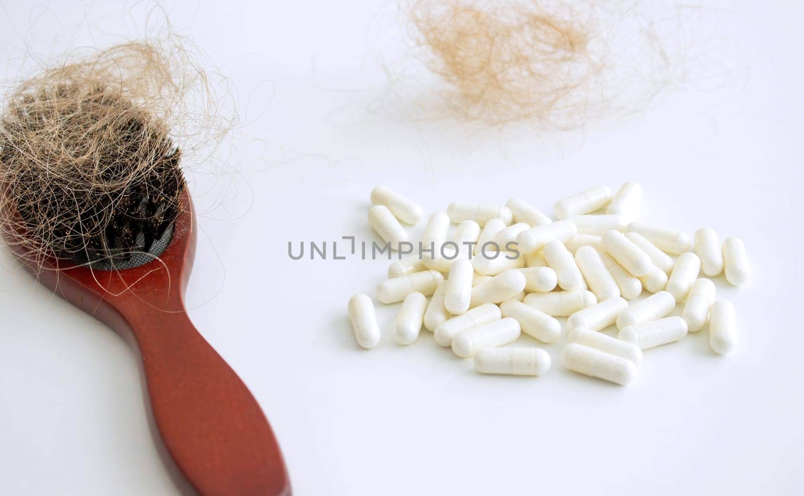 hair brush with hair and vitamins. hair loss.