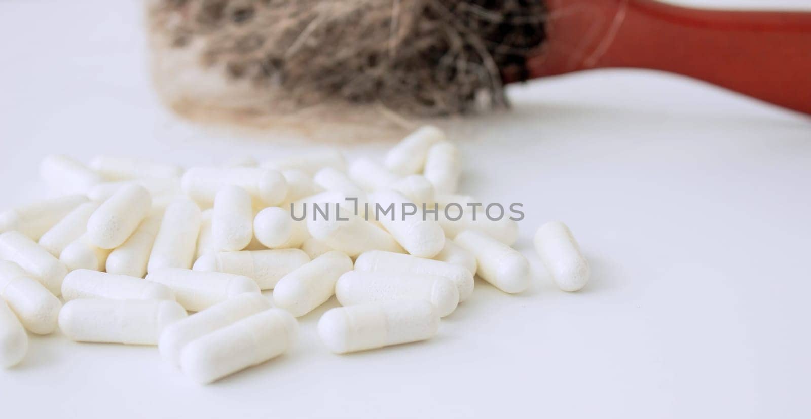 hair brush with hair and vitamins. hair loss.