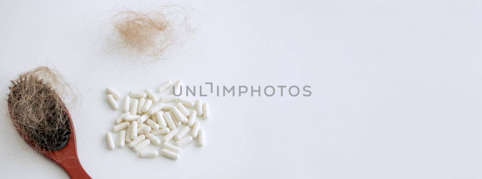 hair brush with hair and vitamins. hair loss.