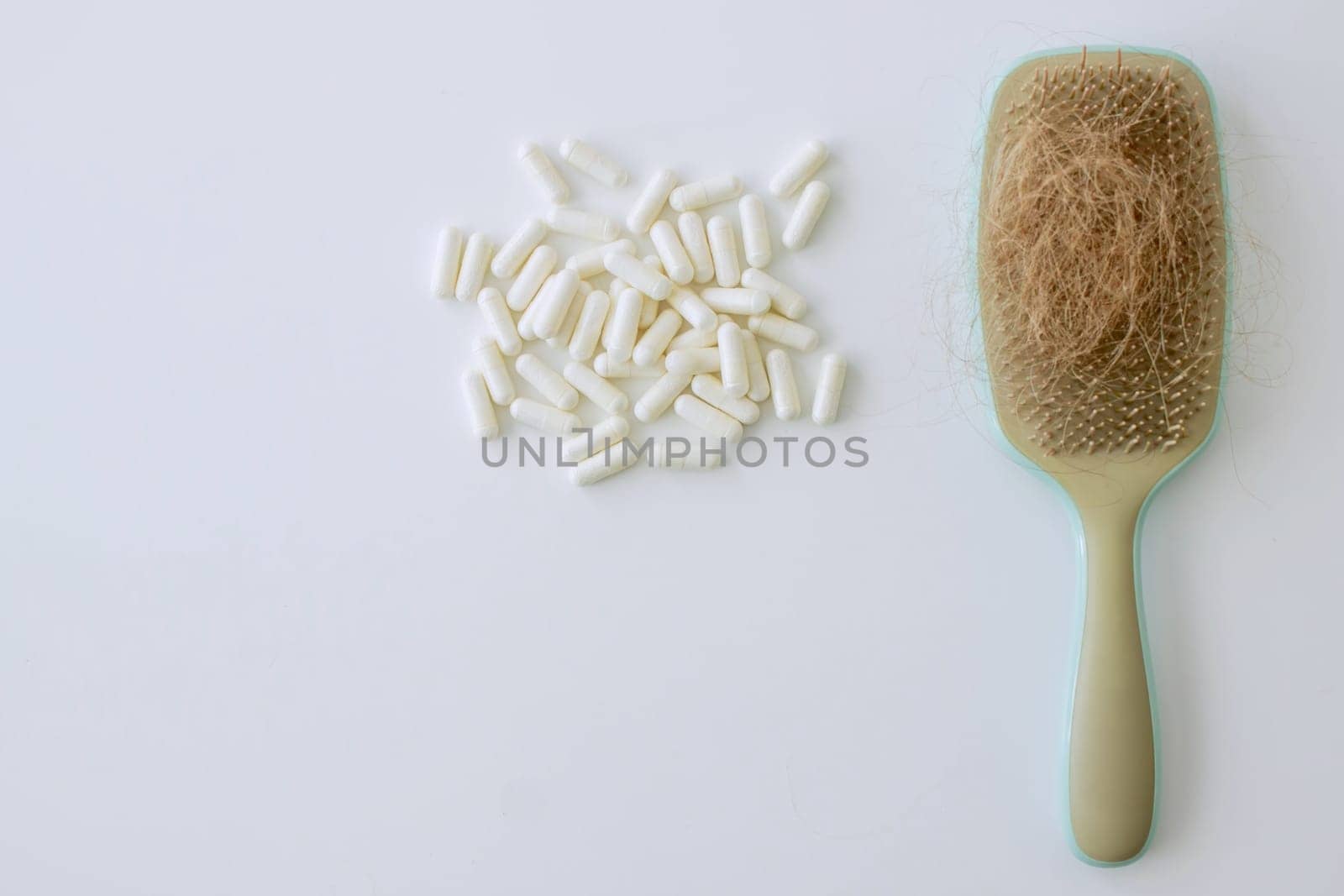 hair brush with hair and vitamins. hair loss.