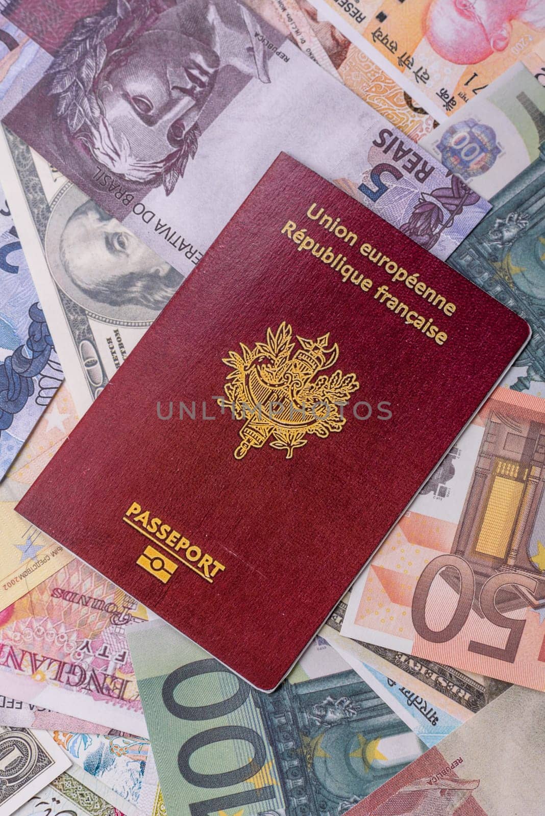 International passport of a citizen of France on background of paper banknotes of different countries