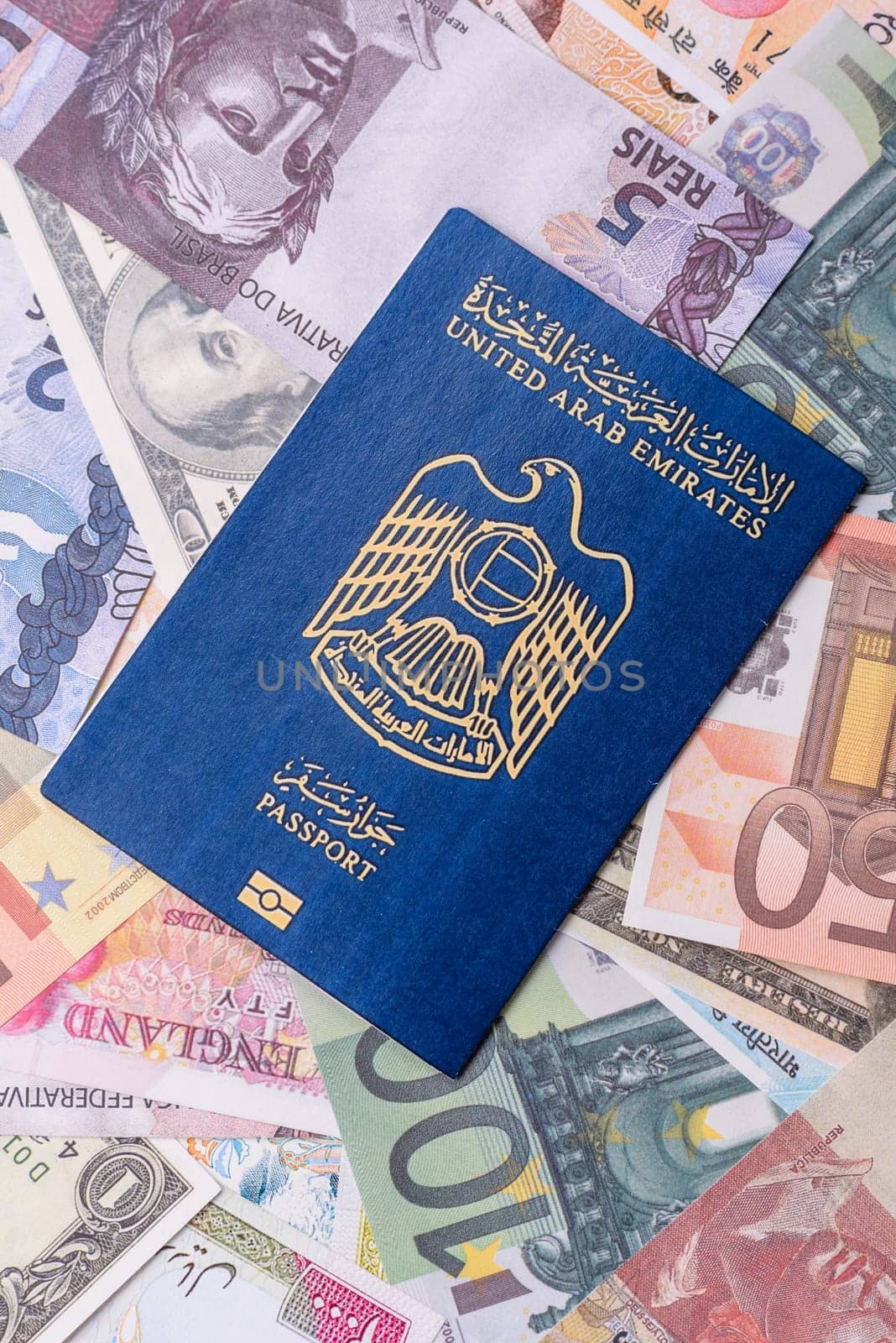 International passport of a citizen of United Arab Emirates against the paper banknotes