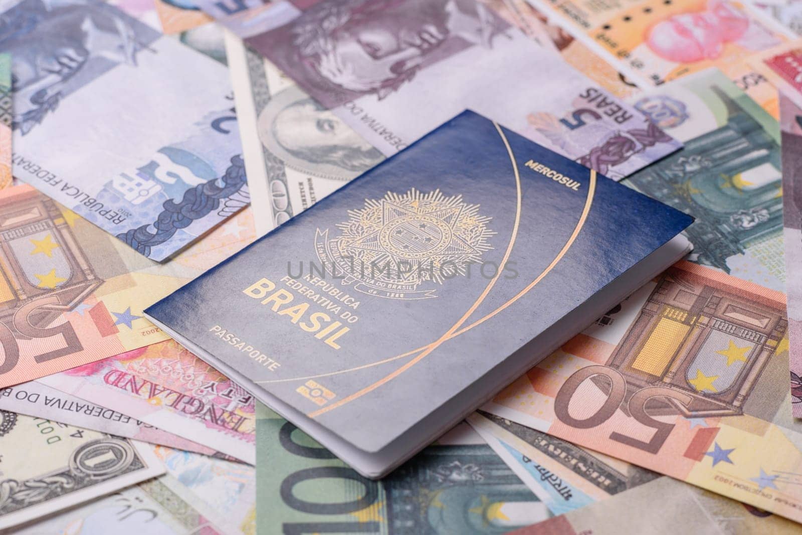 International passport of a citizen of Brazil on a background of paper banknotes of different countries