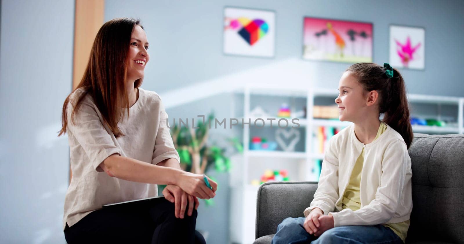Young Child Therapist Comforts Depressed Kid During Counseling Session. Surgeon Writes Medical Document for Blind Patient Waiting in Hospital.
