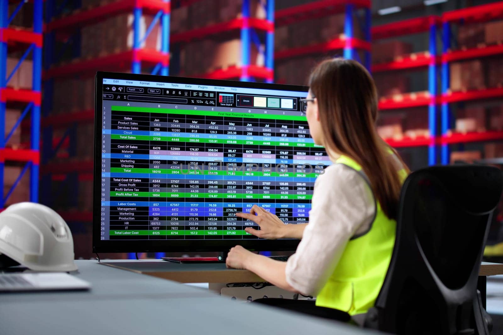 Female Warehouse Manager Using Inventory Software on Office Computer System